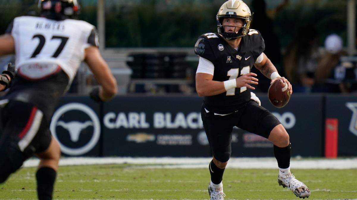 Central Florida quarterback Dillon Gabriel, right, scrambles against Cincinnati during the first half of an NCAA college football game, Saturday, Nov. 21, 2020, in Orlando, Fla.