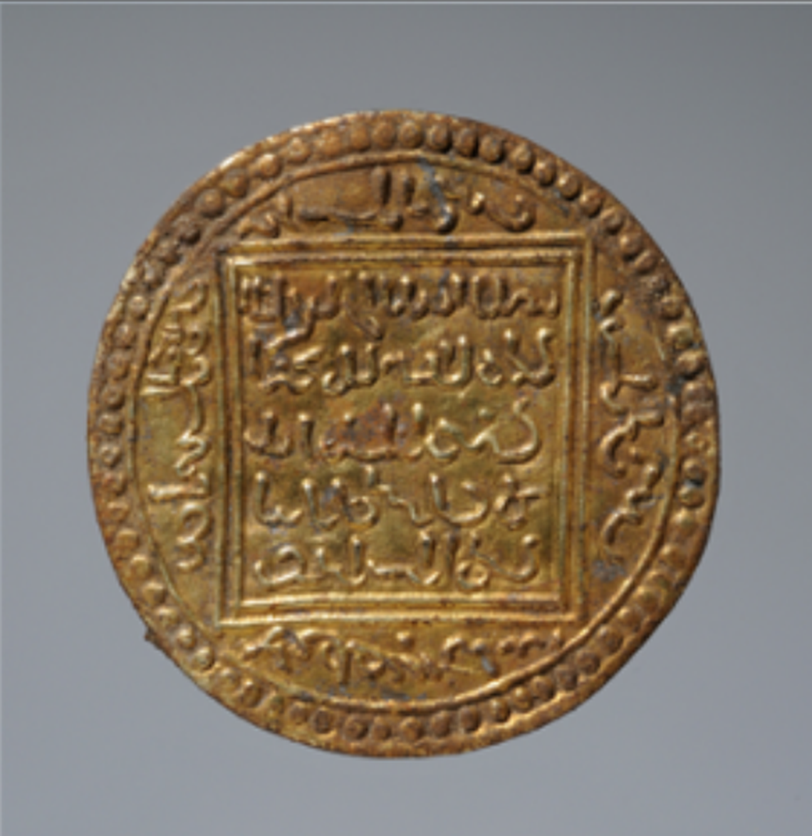 The imitation gold coin used as a robe clasp.