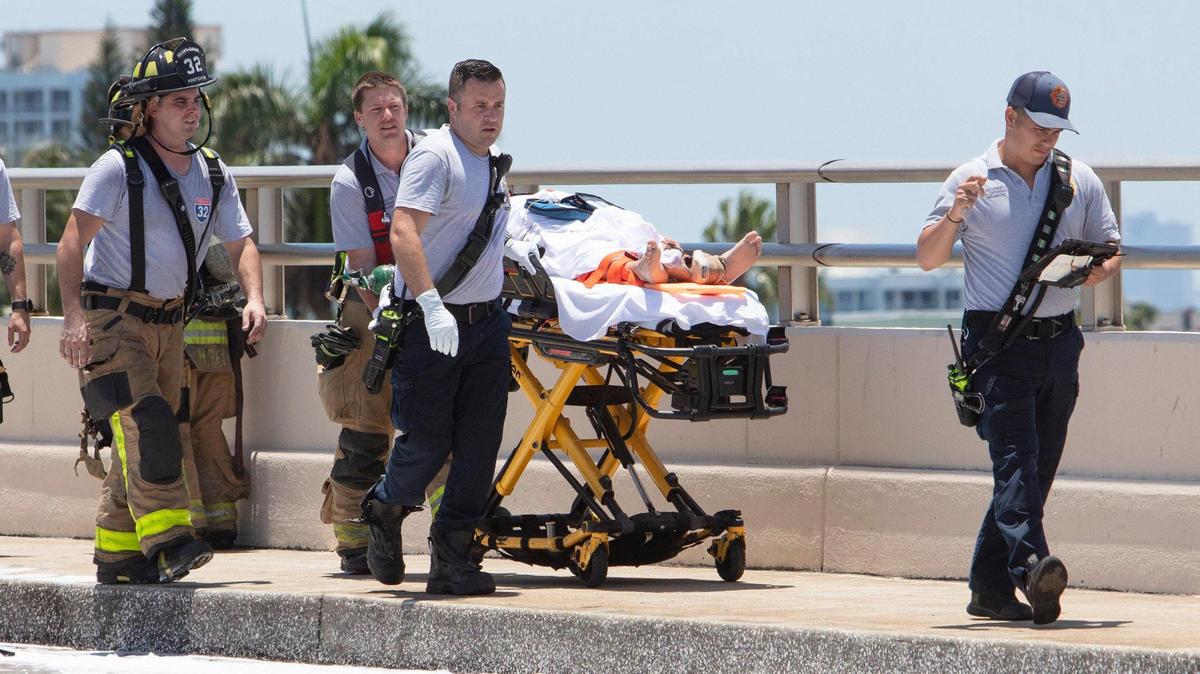 Miami-Dade rescue crews transport an injured patient after a plane hit the Haulover Bridge on Saturday.
