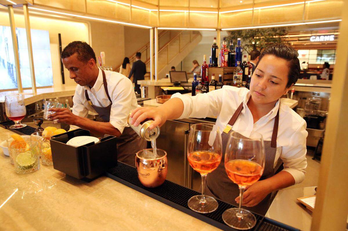 Bartenders Rozano Johnson and Juana Pineda serve up cocktails at the Aperitivo Bar located on the second level of Brickell City Centre’s La Centrale Wednesday afternoon, Feb. 7, 2018. La Centrale’s 40,000 square-foot venue offers 14 different Italian eateries and five bars and over 1,000 specialty retail products, spanning three levels. The grand opening for the public will be on Feb. 16.