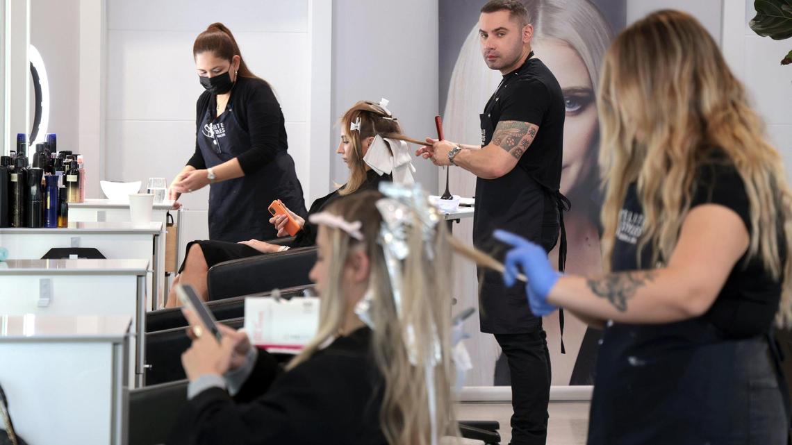 Beto Pellegrino, 41, hairstylist and co-owner of Elite Styles Salon & Med Spa in Edgewater colors the hair of client Daria Edusewicz, 32, with assistance from Norma Pineda. Employers in Edgewater struggle to retain and find talent because of the rising cost of living and apartment rent hikes in the Miami neighborhood. elite