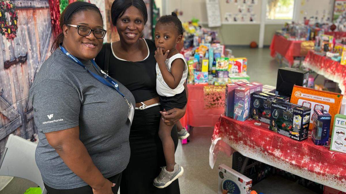 A Branches parent at the Branches Florida City “Under the Tree Toy Shops” purchases holiday gifts for children at a 90% discount. Volunteers wrap the presents.