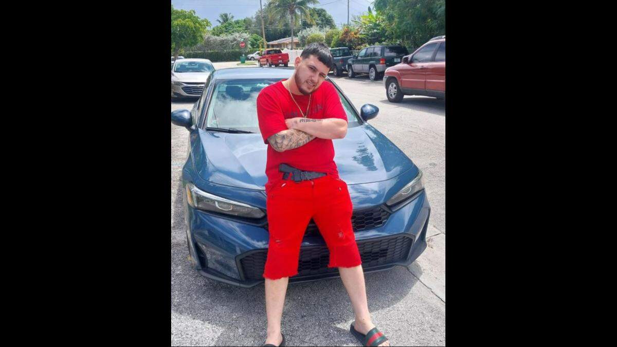 Mason Triana is seen leaning against the front of a car with a handgun in his waistband in a Sept. 8, 2025, post on his Facebook page.