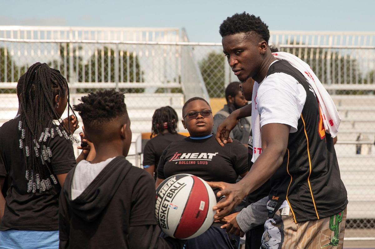Heat player Victor Oladipo talks to kids during the Afterschool All Stars clinic of guided instruction on dribbling and passing, strength and conditioning, and shooting form.