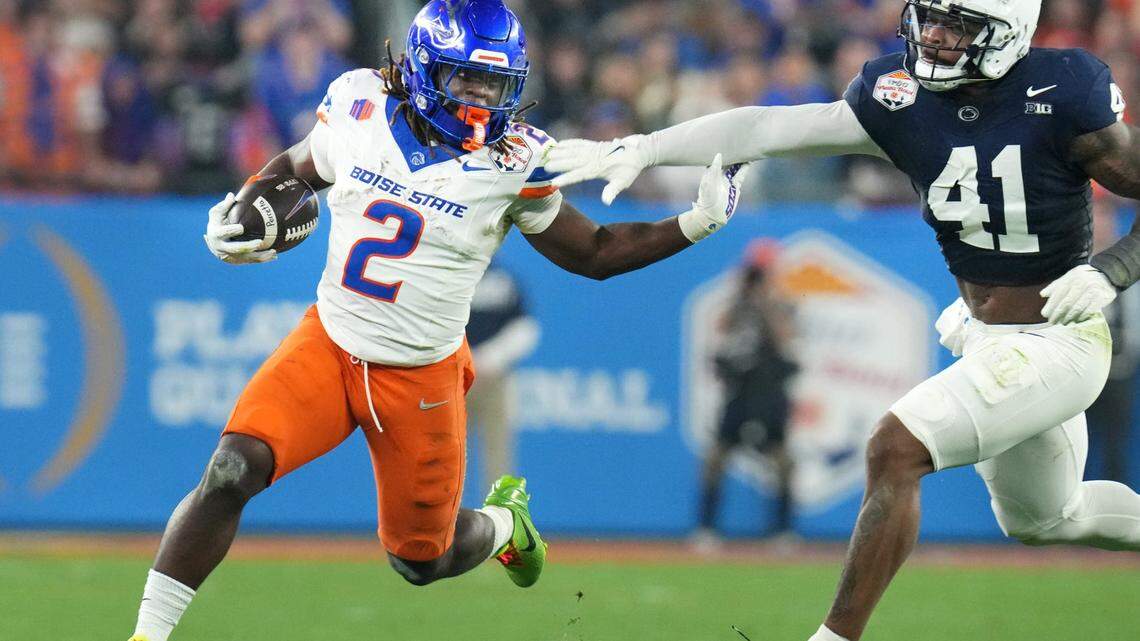 Boise State Broncos running back Ashton Jeanty (2) runs past Penn State Nittany Lions linebacker Kobe King (41) during their Vrbo Fiesta Bowl matchup at State Farm Stadium on Dec. 31, 2024.