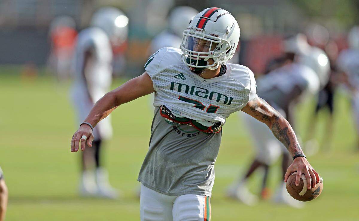 Miami Hurricanes safety Bubba Bolden (21) handles the football during practice at the University of Miamis Greentree Field in Coral Gables on Thursday, August 12, 2021.