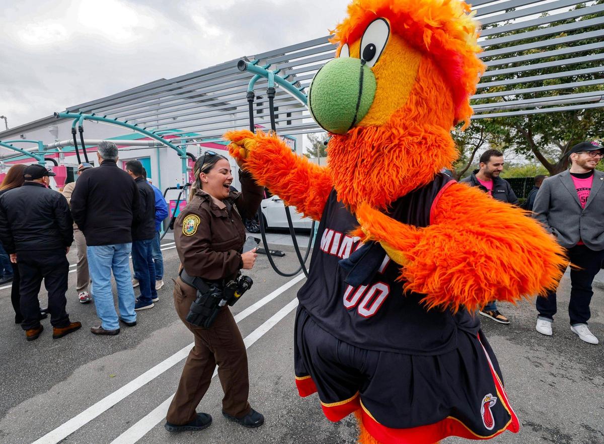 Miami Heat mascot Burnie, dances with Miami-Dade Police Deputy Liannet Gomez during El Car Wash’s celebration of its expansion to over 50 locations in Michigan and Florida. The company also gives back to the community with a $150,000 donation to Baptist Health for pediatric cancer research, marking the third consecutive year of support with over $300,000 raised to date in Miami, Florida on Friday, January 24, 2025.