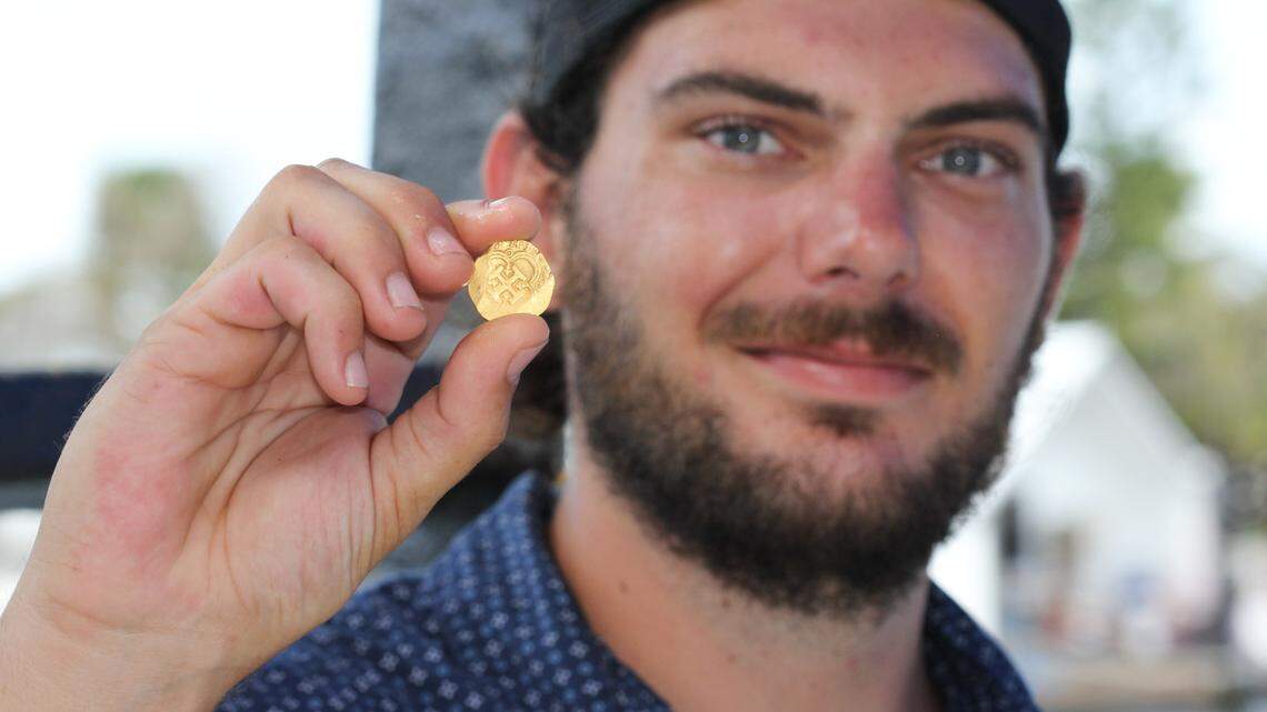 Zach Moore, a diver and engineer for Mel Fisher’s Treasures in Key West, holds the rare gold coin he found July 16, 2021, while searching the wreck of a Spanish galleon that sank in 1622.