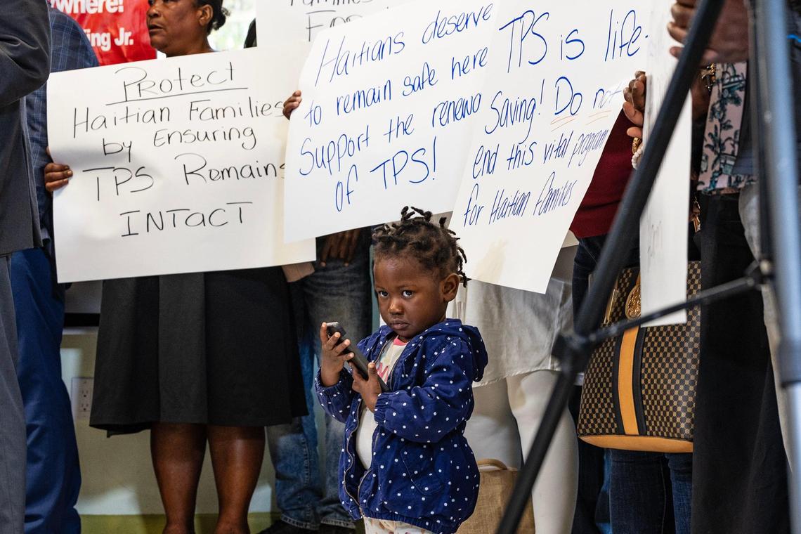 Jenny Bellus, 22 months old, with her mother Rose-Myrlene Elmond, a TPS holder, during a press conference called by the Family Action Network Movement to discuss the roll back of Haiti TPS by the Trump administration.