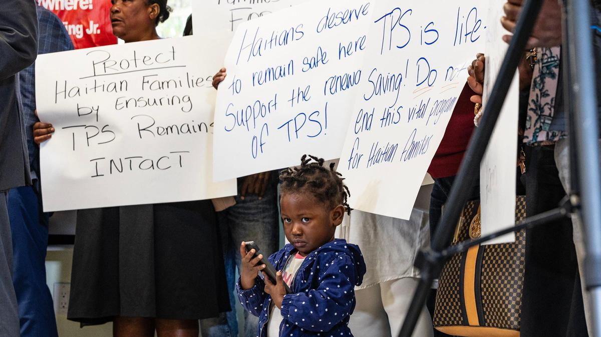 Jenny Bellus, 22, months old, reacts as she attends with her mother Rose Myrlene Elmond, a TPS holder, during a press conference called by the Family Action Network Movement to discuss the roll back of Haiti TPS by President Trump administration affecting thousand of Haitian Families, on Friday, February 21, 2025.