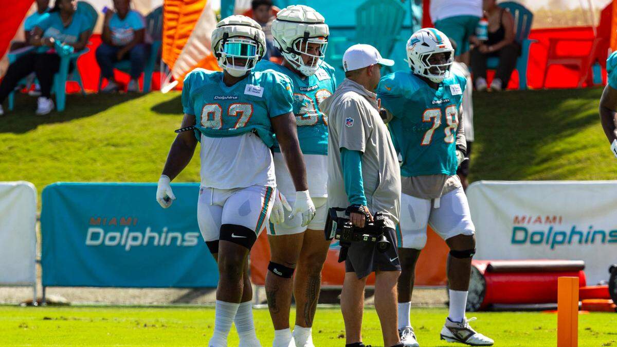 Miami Dolphins defensive tackles Brandon Pili (96), Isaiah Mack (97) and Leonard Payne (78) react during training camp at Baptist Health Training Complex on Tuesday, August 13, 2024, in Miami Gardens, Fla.