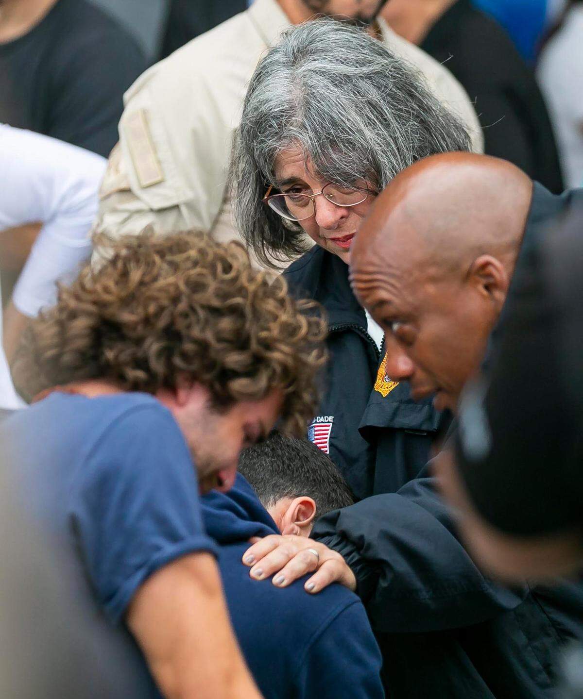 Miami-Dade County Mayor Daniella Levine Cava and County Commissioner Oliver G. Gilbert console people waiting for updates from the Champlain Towers collapse site at a reunification center at 9301 Collins Ave. in Surfside on Thursday, June 24, 2021. 