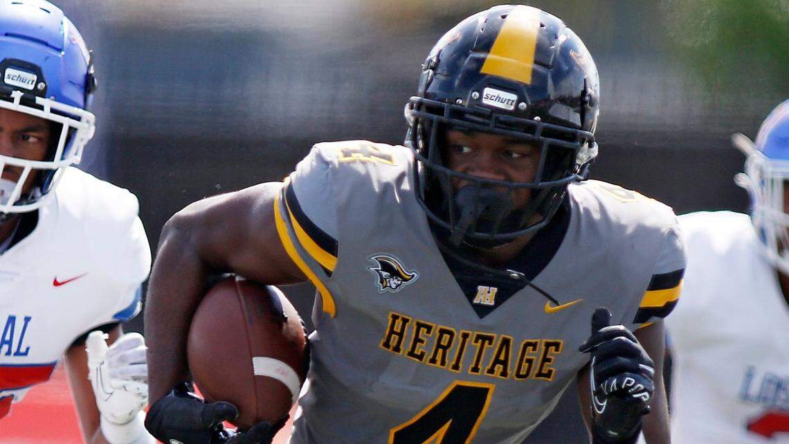 American Heritage Patriots running back Mark Flecher (4) carries the ball againsty Los Alamitos High (CA) during football game on Saturday, August 27, 2022 at St. Thomas Aquinas HS in Fort Lauderdale. Andrew Uloza / for Miami Herald