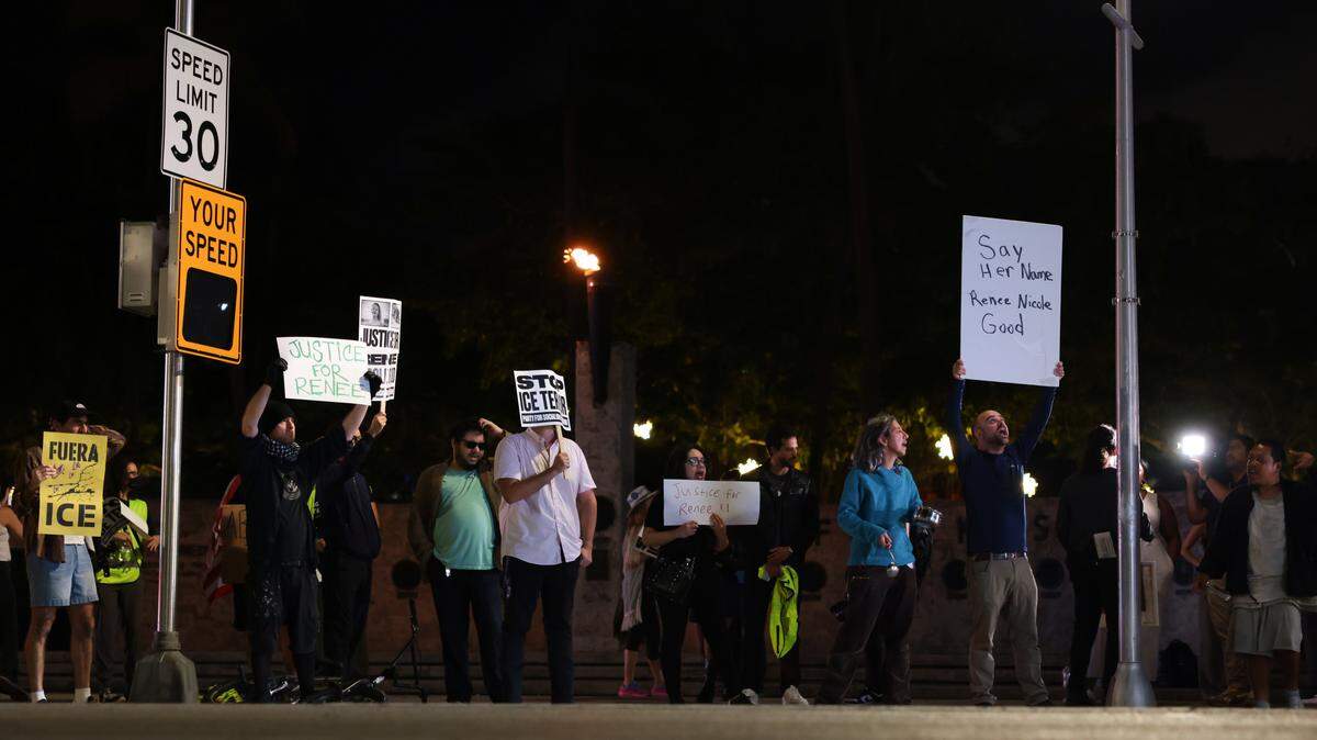 Protesters hold signs while chanting during a protest against ICE at the Torch of Friendship monument at 401 Biscayne Blvd., in downtown Miami on Wednesday, Jan. 7, 2026.