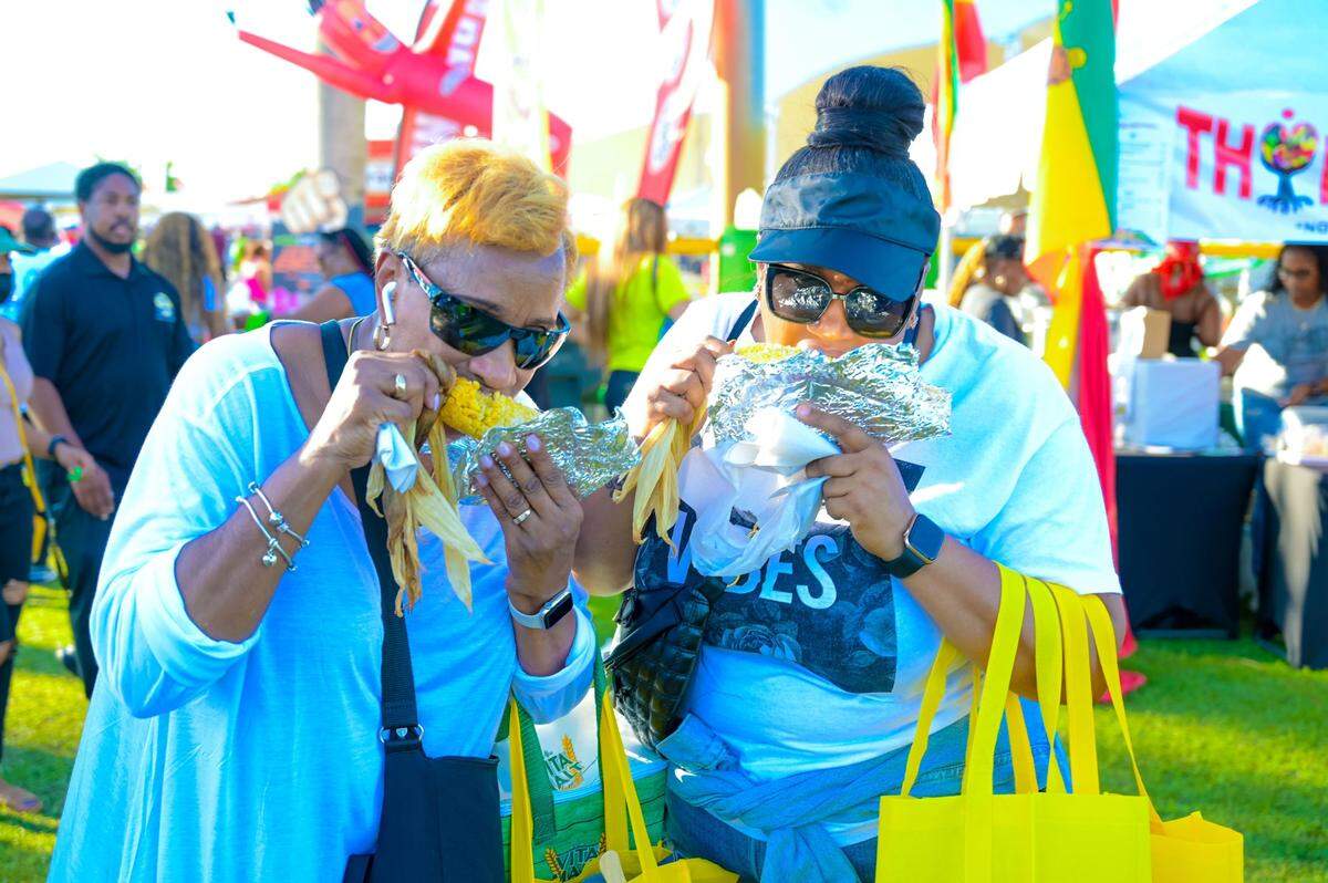 Guests enjoy roast corn at a previous Grace Jamaican Jerk Festival. Other food favorites available for purchase include jerk chicken, oxtail and curried goat.