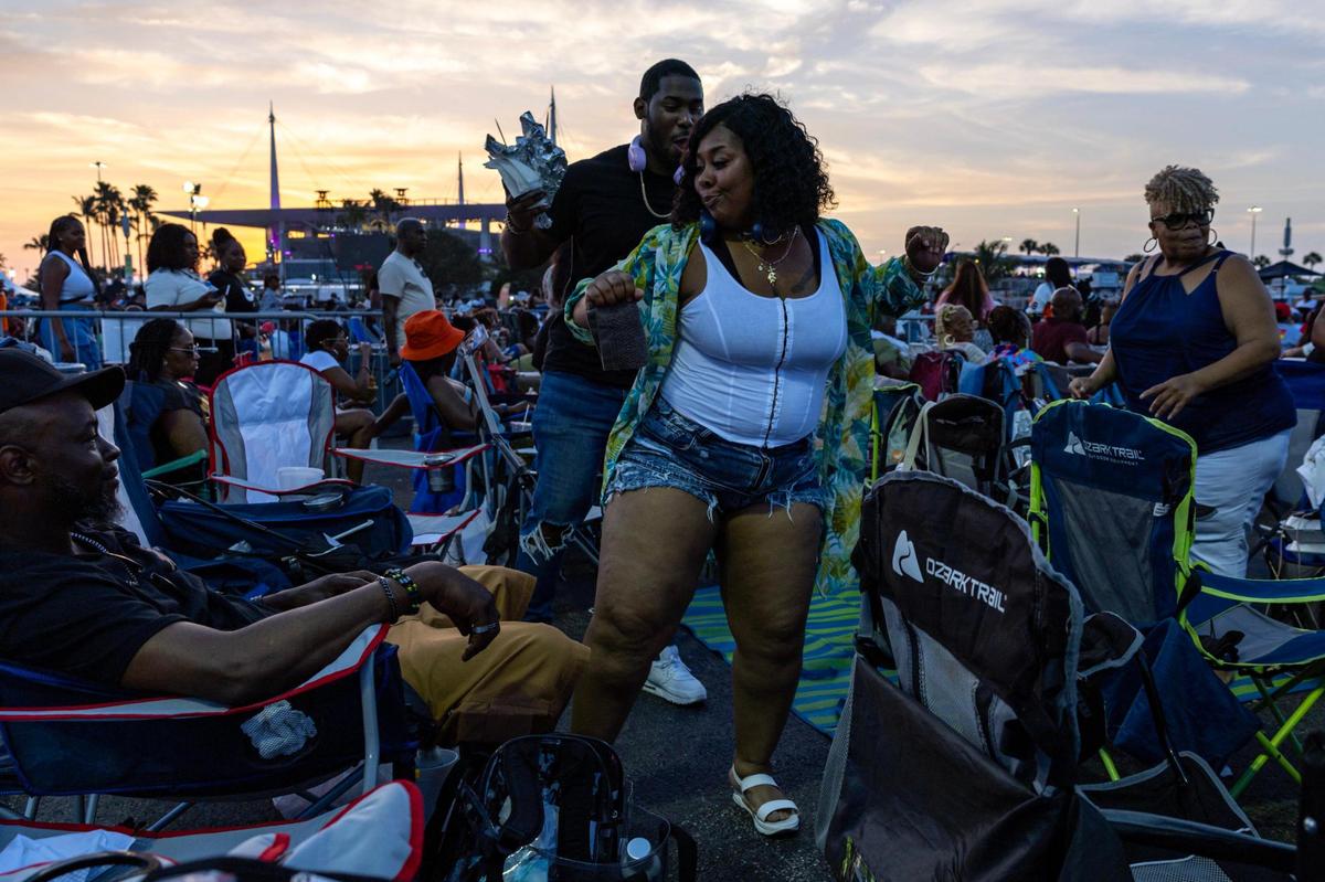 Andrea Nicoleau-Register, 37, right, and Courtney Johnson, 30, left, dance to the music during Jazz in the Gardens at Hard Rock Stadium Arena in Miami Gardens, Florida, on Saturday, March 9, 2024.