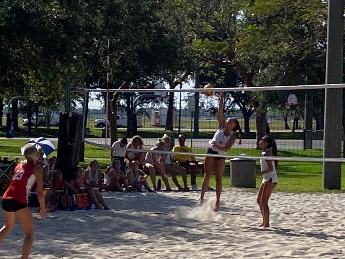 St. Thomas Aquinas’ Alyssa McBean spikes the ball as teammate Halley Tang watches during the Raiders’ 3-2 win over Cardinal Gibbons on Monday at Pompano Beach Community Park.