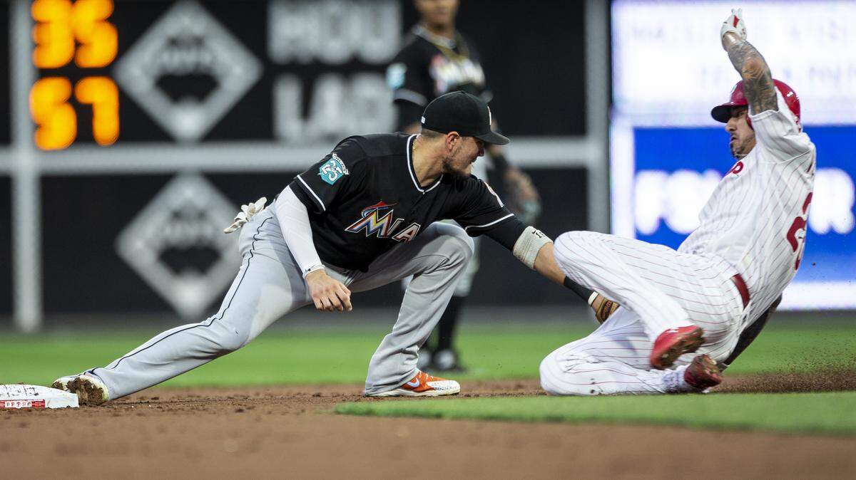 Philadelphia Phillies’ Vince Velasquez slides into second with a double before Miami Marlins shortstop Miguel Rojas (19) can make the tag during the third inning of a baseball game Friday, Aug. 3, 2018, in Philadelphia. (AP Photo/Laurence Kesterson)