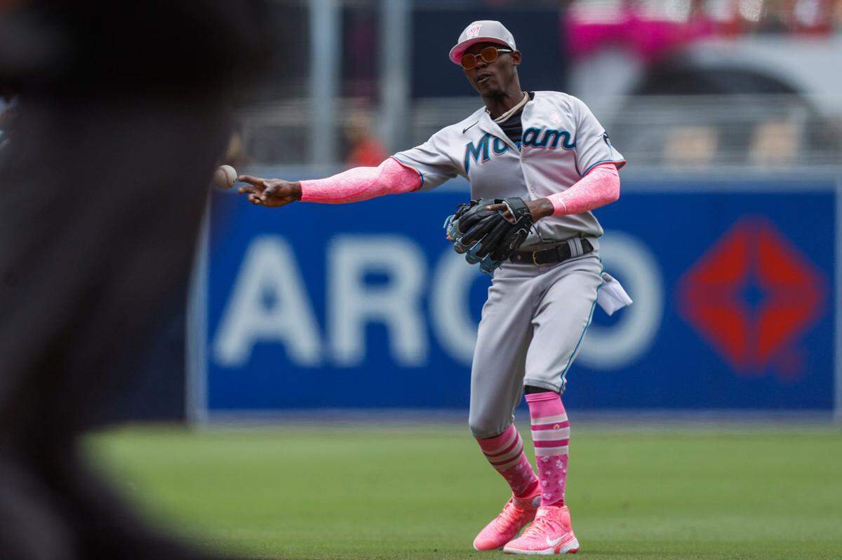 Miami Marlins’ Jazz Chisholm throws to first base to retire San Diego Padres’ Trent Grisham during the second inning of a baseball game Sunday, May 8, 2022, in San Diego. (AP Photo/Mike McGinnis)