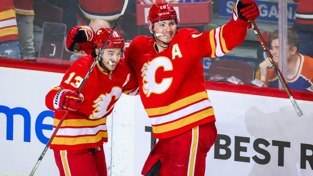 May 18, 2022; Calgary, Alberta, CAN; Calgary Flames left wing Matthew Tkachuk (19) celebrates his goal with left wing Johnny Gaudreau (13) during the third period against the Edmonton Oilers in game one of the second round of the 2022 Stanley Cup Playoffs at Scotiabank Saddledome. Mandatory Credit: Sergei Belski-USA TODAY Sports
