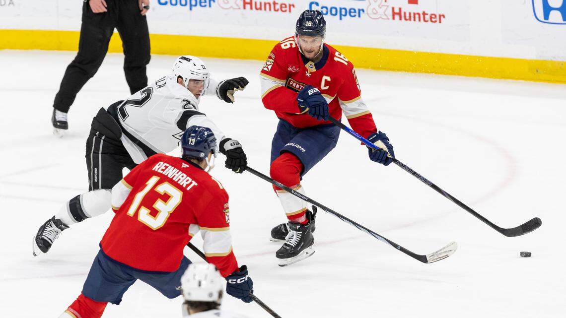 Florida Panthers center Aleksander Barkov (16) passes the puck to center Sam Reinhart (13) as Los Angeles Kings left wing Kevin Fiala (22) defends in the first period of their NHL game at Amerant Bank Arena on Wednesday, Jan. 29, 2025, in Sunrise, Fla.