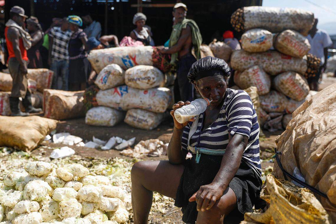 A vegetable vendor waits for customers at the La Saline market during a strike in Port-au-Prince, Haiti, Tuesday, Oct. 26, 2021. Worker unions along with residents called for a general strike to demand the end of kidnappings, violence and insecurity in the streets.