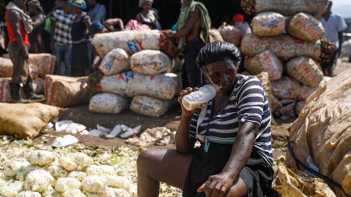 A vegetable vendor waits for customers at the La Saline market during a strike in Port-au-Prince, Haiti, Tuesday, Oct. 26, 2021. Worker unions along with residents called for a general strike to demand the end of kidnappings, violence and insecurity in the streets.