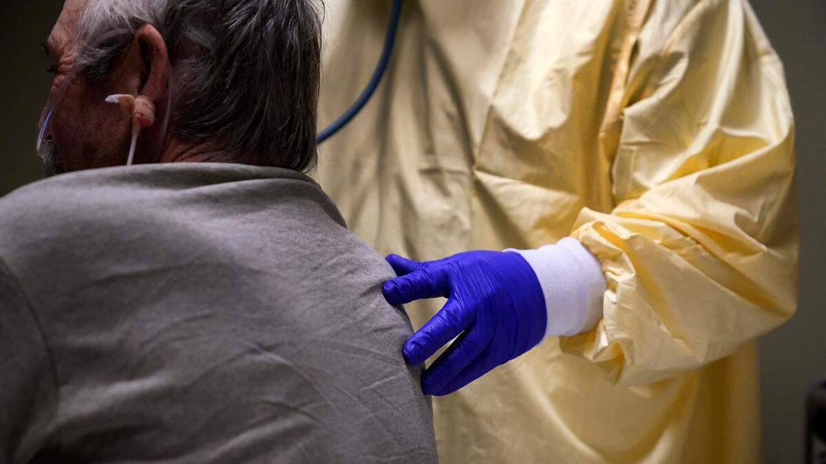 A doctor listens to a COVID-19 patient’s lungs in Memphis, Missouri, in November 2020. Hospitalized COVID-19 patients may have long COVID symptoms and money struggles in the months after their discharge, a study found.