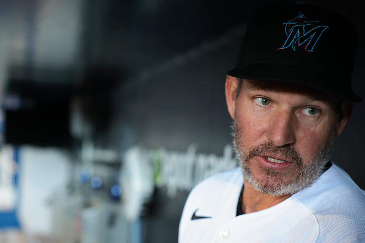 Miami Marlins manager Clayton McCullough (86) speaks to reporters inside the dugout during media day at loanDepot park on Friday, Feb. 6, 2026, in Miami, Fla.