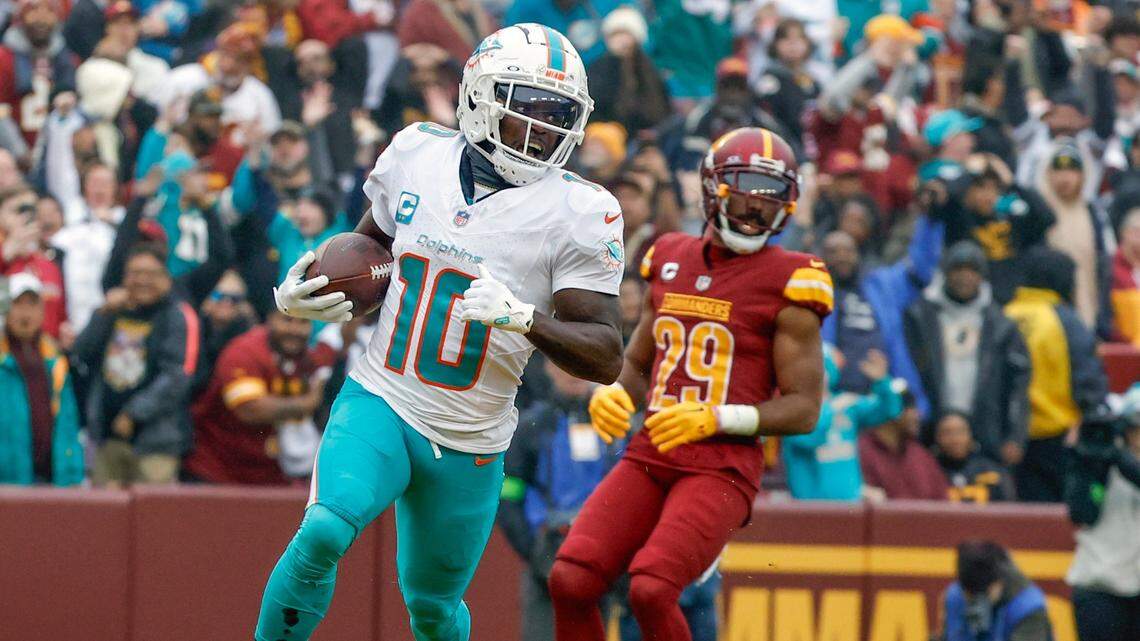 Miami Dolphins wide receiver Tyreek Hill (10) scores in the second quarter during the game against the Washington Commanders at FedEx Field in Landover, Maryland on Sunday, December 3, 2023.