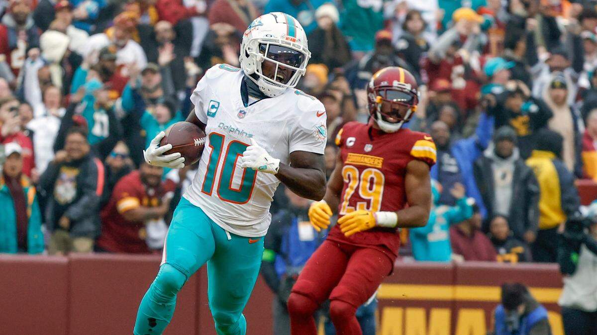 Miami Dolphins wide receiver Tyreek Hill (10) scores in the second quarter during the game against the Washington Commanders at FedEx Field in Landover, Maryland on Sunday, December 3, 2023.