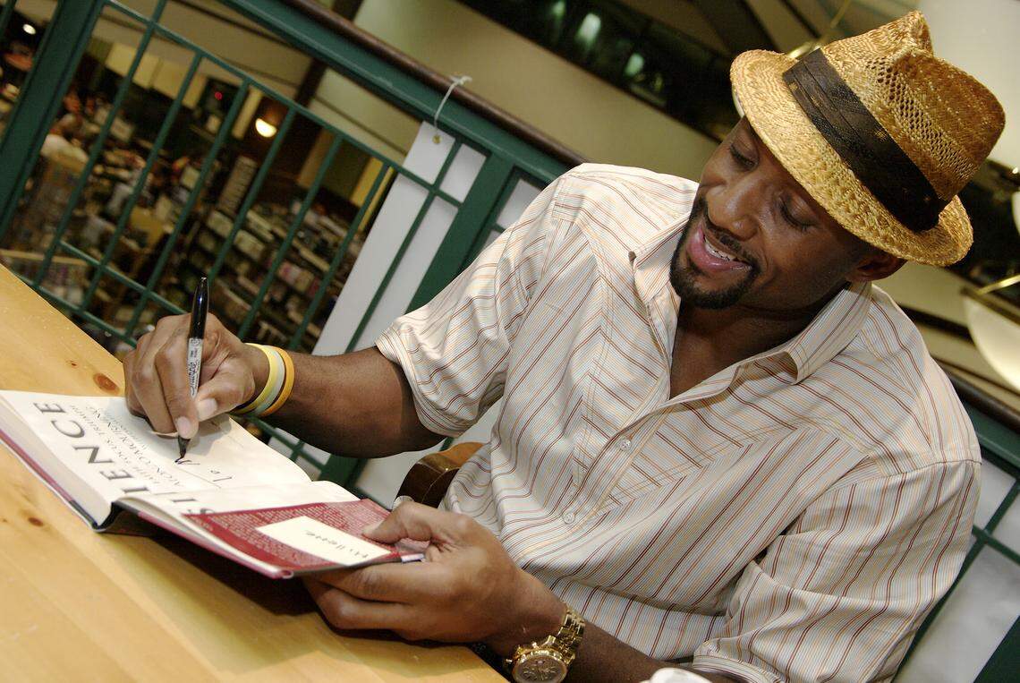 In this file photo from Oct. 3, 2008, then-Miami Heat player Alonzo Mourning signs copies of his book, “Resilience” for a fan at Barnes & Noble booksellers in the Kendall Village West shopping plaza.