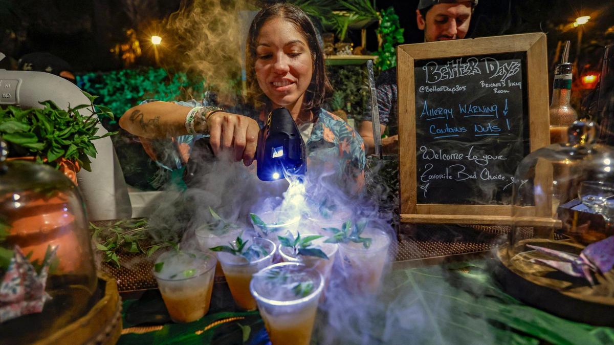 Lexi Tollinchi, with Better Days, prepares cocktails during the Art of Tiki Cocktail Showdown at the South Beach Wine & Food Festival at the Kimpton Surfcomber Hotel in Miami Beach, Florida on Saturday, February 25, 2023.