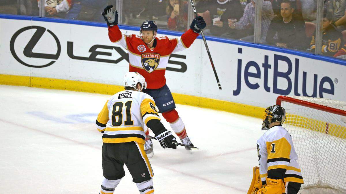 Florida Panthers defenseman Mike Matheson (19) celebrates after scoring the winning goal against the Pittsburgh Penguins goalie Casey DeSmith (1) during the overtime of an NHL regular season hockey game at the BB&T Center on Thursday, February 7, 2019 in Sunrise. The Panthers won 3-2 in overtime.