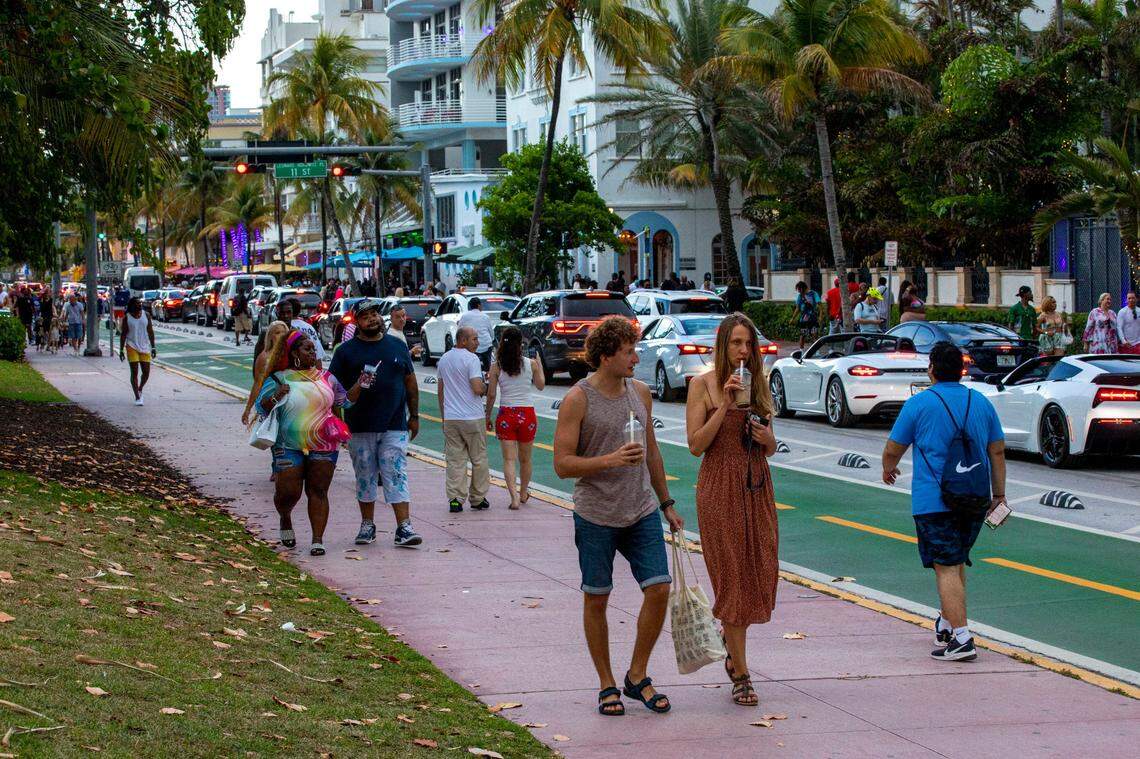 People walk Ocean Drive in South Beach during Memorial Day weekend in Miami Beach on Saturday, May 28, 2022.