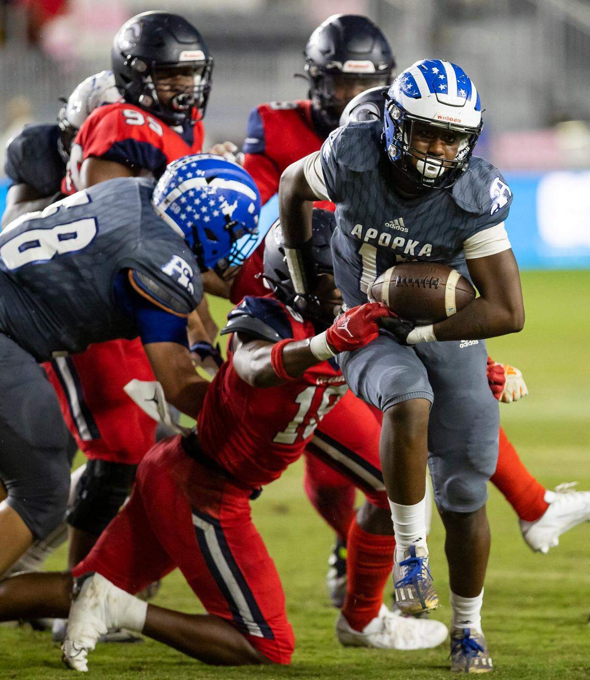 Columbus Explorers defensive end Dylan Stephenson (18) forces Apopka Blue Darters quarterback Kaleb Hicks (17) to fumble the ball during the first quarter of their 2022 FHSAA State Championships-Class 4M football game on Saturday, Dec. 17, 2022, in Fort Lauderdale, Fla.