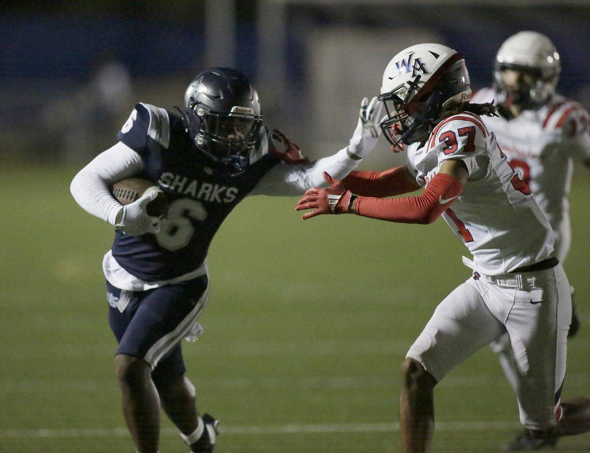 NSU University School Shar ks cornerback Brandon Williams Jr. (6) attempts to evade a tackle by Westminster Academy Lions during the Sunshine State Athletic Association quarterfinal football game on Friday, November 7, 2025 at AutoNation Field in Davie. Andrew Uloza / for Miami Herald