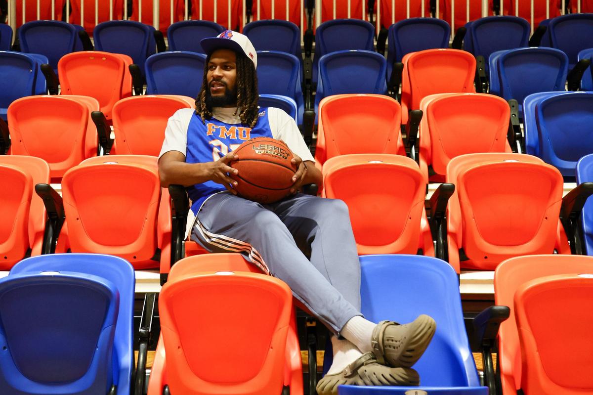 Florida Memorial University basketball player and Miami Pro League star Latavious Mitchell, 26, of team Draft City, sits on the bleachers while holding a basketball inside the Florida Memorial University Wellness Center at 15800 NW 42nd Ave. in Miami Gardens, Florida, on Friday, Aug. 30, 2024.