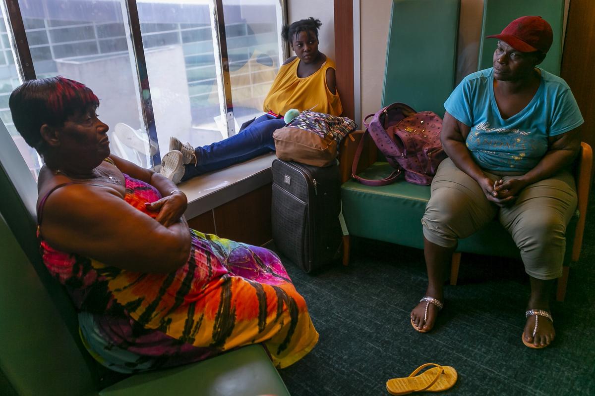 From left to right: Ann Smith, 71, her granddaughter, Marlena Mazard, 12, and her daughter, Lisa Romer, 51, arrive to the Port of Palm Beach aboard the Grand Celebration cruise ship from Freeport, Bahamas on Saturday, September 7, 2019. They are among hundreds of Bahamians that left the island after Hurricane Dorian devastated their homes.