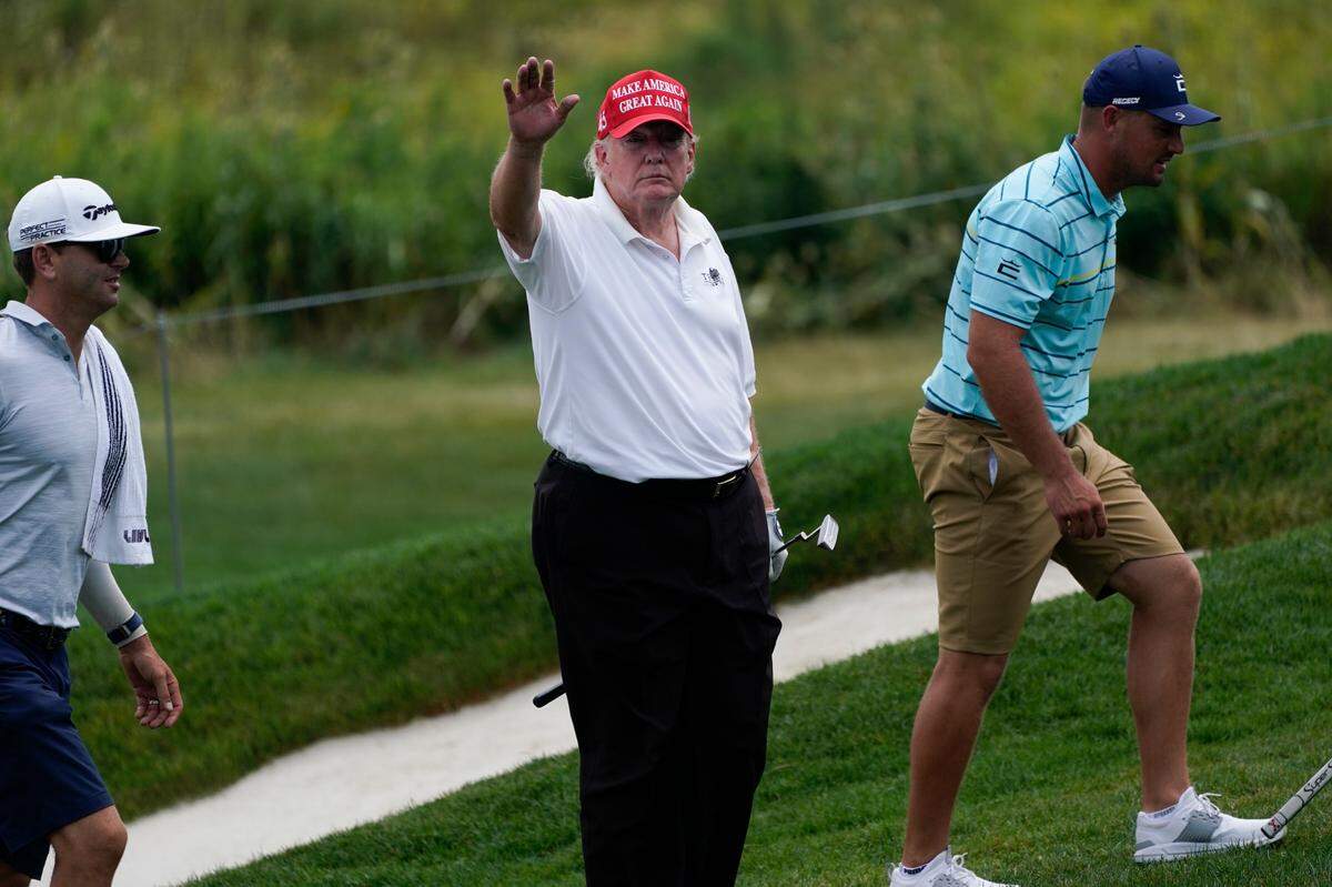 Former President Donald Trump waves while playing during the pro-am round of the Bedminster Invitational LIV Golf tournament in Bedminster, NJ., Thursday, July 28, 2022.