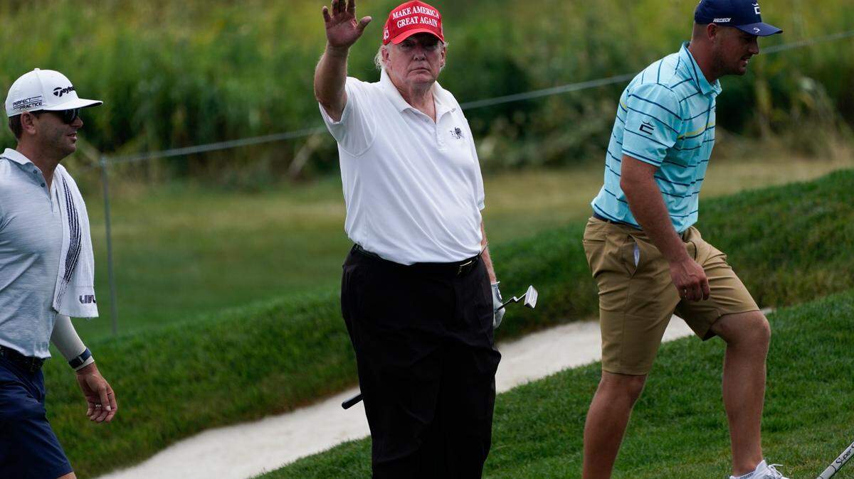 Former President Donald Trump waves while playing during the pro-am round of the Bedminster Invitational LIV Golf tournament in Bedminster, NJ., Thursday, July 28, 2022.