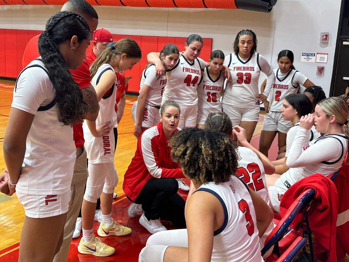 Doral Academy girls’ basketball coach Allison Bustamante speaks to her players during a timeout on Friday in the Region 4-7A final at Doral.