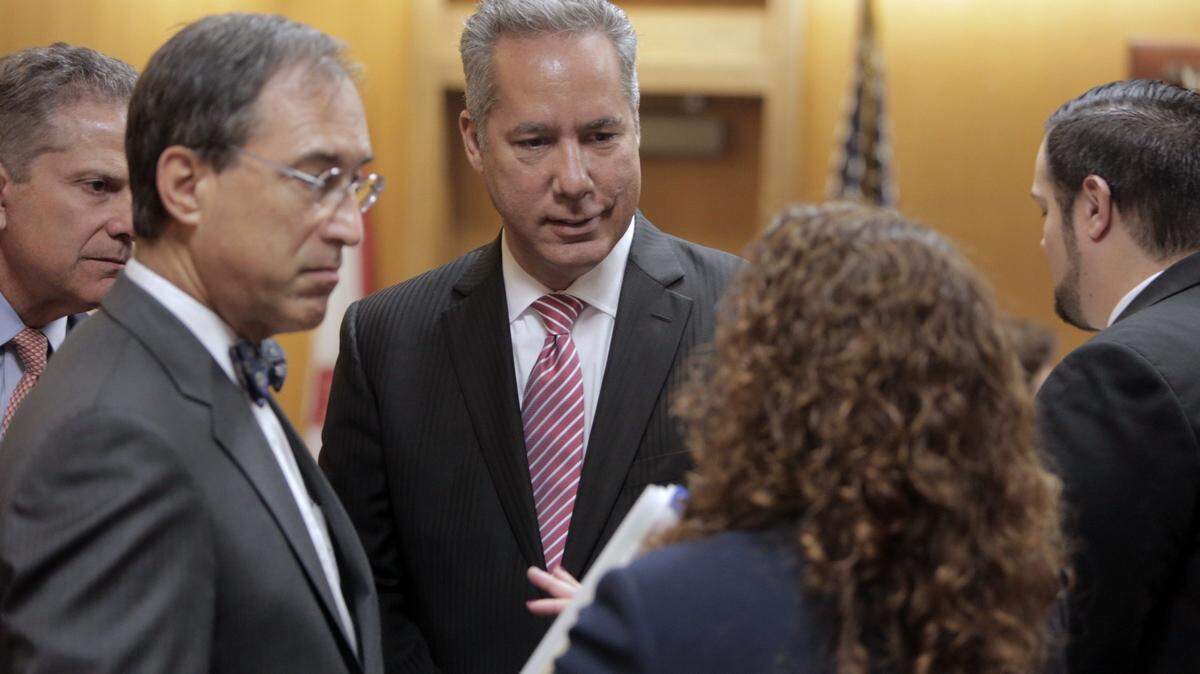 North Miami Beach Mayor George Vallejo (center) gathers with his attorneys in courton April 10. Mr. Vallejo pleaded guilty to a campaign finance violation as part of a plea deal worked out in advance and resigned from office.