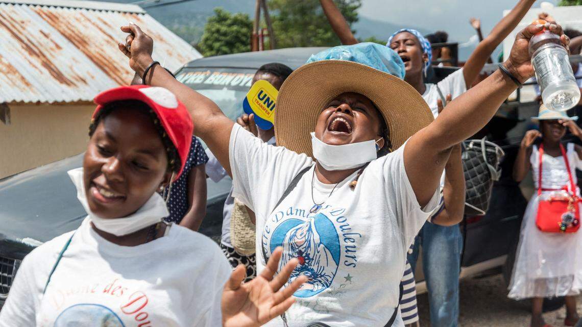 A pilgrim shouts hallelujah as she worships during the Benediction at the Way of the Cross procession during Easter Holy Week in Port-au-Prince, April 2, 2021.