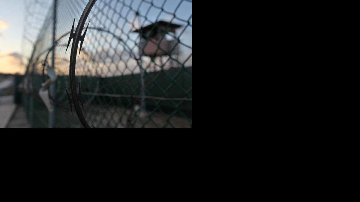 In this May 13, 2009 file photo reviewed by the U.S. military, the sun rises over the Guantanamo detention facility at dawn, at the Guantanamo Bay U.S. Naval Base, Cuba.