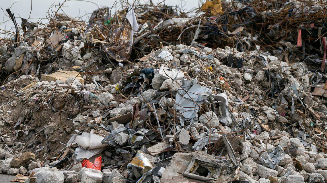 Large piles of debris and rubble from the collapsed Champlain Towers South can be seen inside a lot near the Miami International Airport at the intersection of Milam Dairy Road and Northwest 12th Street in Miami, Florida, on Saturday, July 10, 2021.