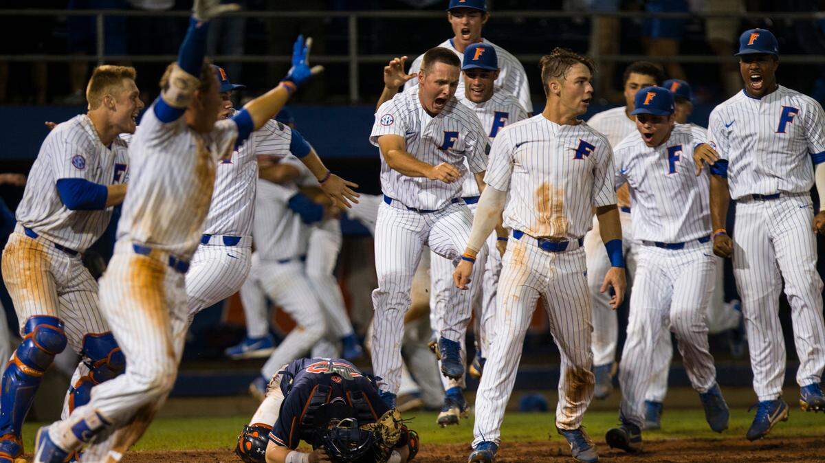 Florida players celebrate after Austin Langworthy hit a walk-off home run to beat Auburn, 3-2, in an NCAA college baseball Super Regional game in Gainesville on Monday. The victory means Florida is headed to the College World Series in Omaha, Nebraska.