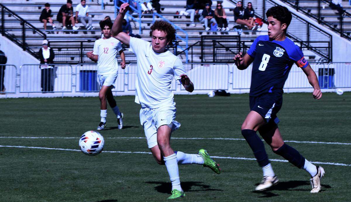 Doral Academy senior defender Miquel Pacifico (3) battles for a 50-50 ball with Lake Nona junior forward Arthur Maranhao during the first half of a Class 7A semifinal at the FHSAA state tournament Monday at Lake Myrtle Sports Park in Auburndale.