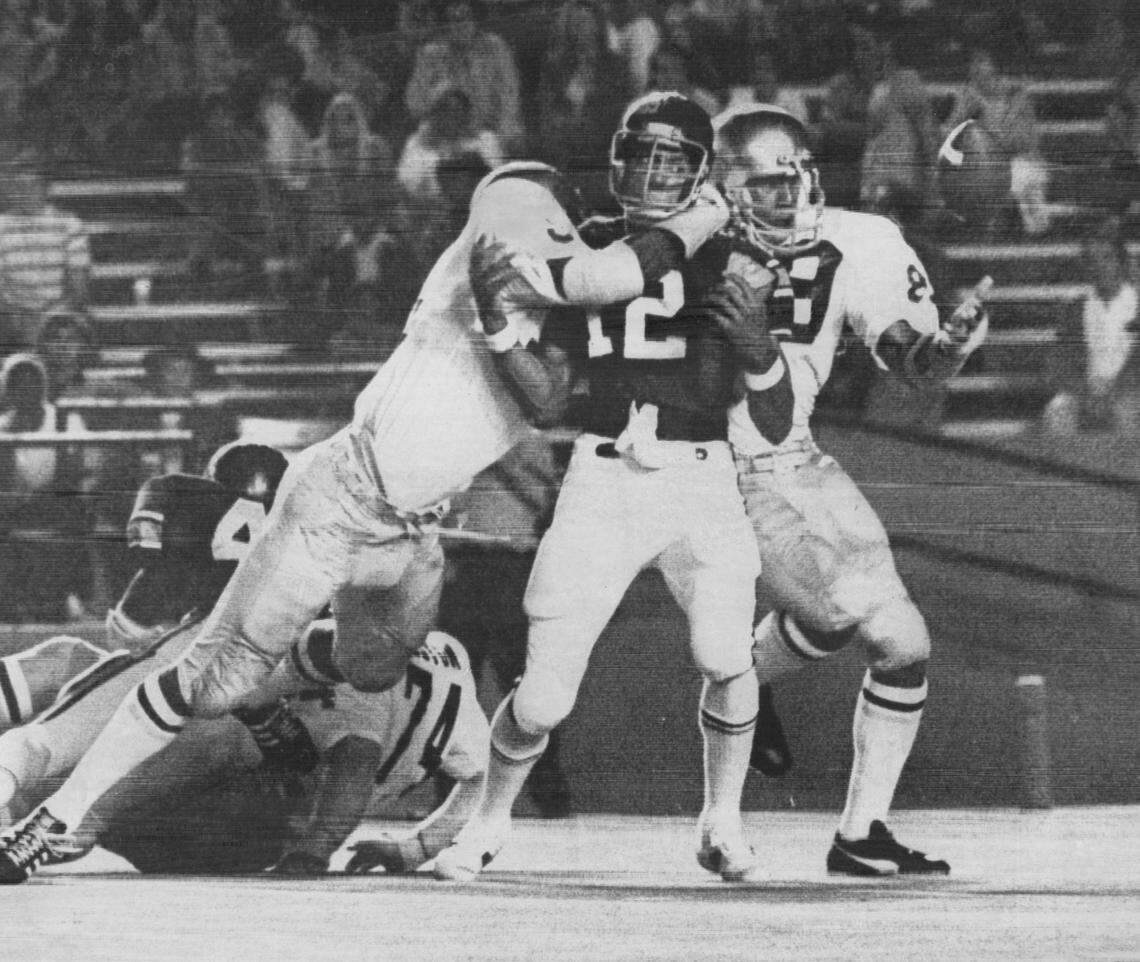 In 1975, University of Miami quarter-back Kary Baker keeps his eyes on the ball he just fumbled after a hit from a Notre Dame defender.