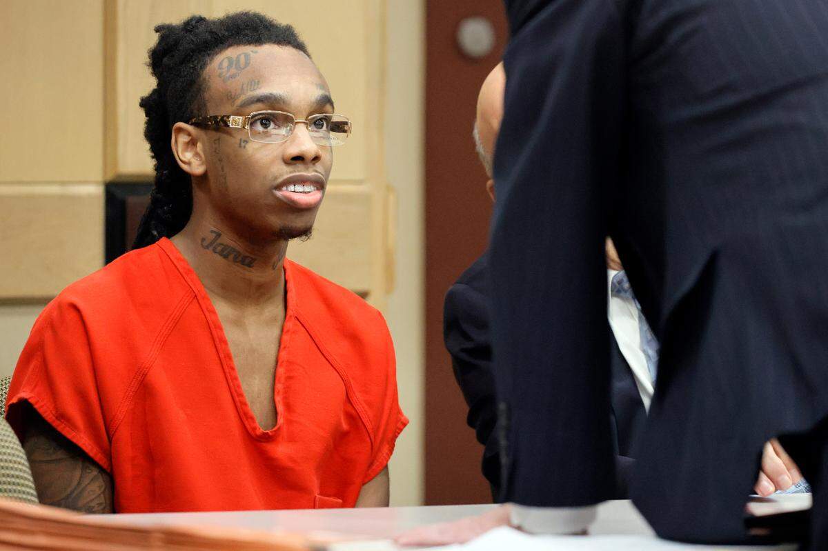 Jamell Demons, better known as rapper YNW Melly, speaks with one of his attorneys during a hearing before his trial at the Broward County Courthouse in Fort Lauderdale on Friday, Oct. 13, 2023. Demons is accused of killing two fellow rappers and conspiring to make it look like a drive-by shooting in October 2018.